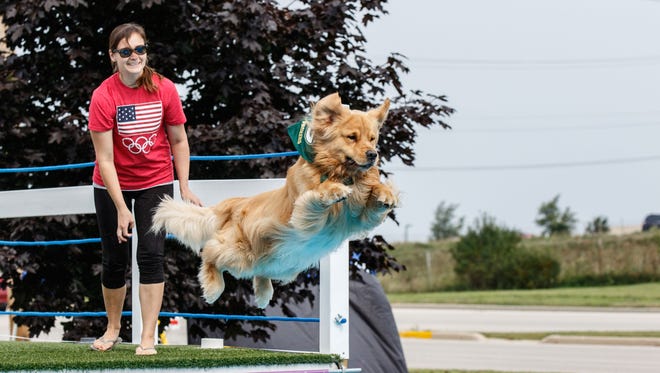 Amanda Rossbach of Hartland sends her dog, Jordy, into the pool during the Pier Pups canine dock jumping competition hosted by Petlicious Dog Bakery in Pewaukee on Sunday, Aug. 20, 2017.