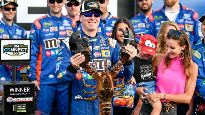 Kyle Busch, holding the traditonal lobster, celebrates with his wife Samantha, son Brexton No. 18 crew after winning the playoff race at New Hampshire Motor Speedway on Sept. 24, 2017.