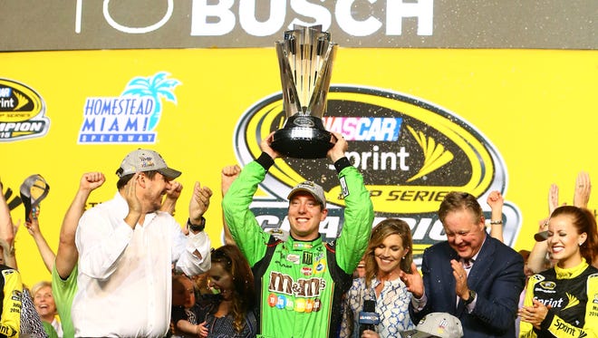Busch celebrates his first career Sprint Cup championship on Nov. 22, 2015. Busch won the season-ending Ford EcoBoost 400 at Homestead-Miami Speedway. to clinch the title.