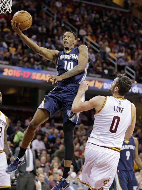 Memphis Grizzlies' Troy Williams (10) shoots over Cleveland Cavaliers' Kevin Love (0) in the second half of an NBA basketball game, Tuesday, Dec. 13, 2016, in Cleveland. The Cavaliers won 103-86. (AP Photo/Tony Dejak)