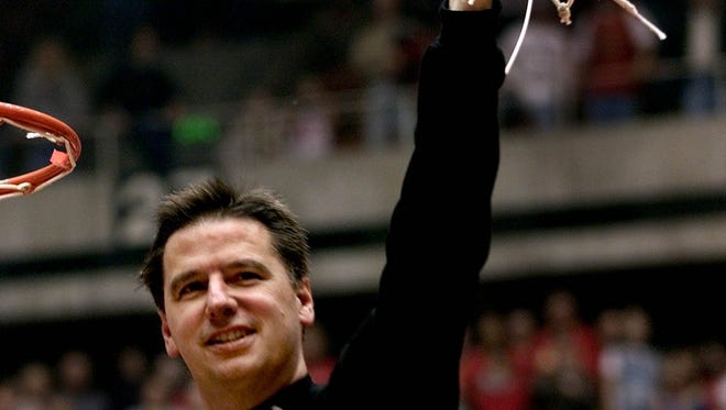 Iowa State coach Larry Eustachy holds up net after he fininshed cutting it down during celebration of winning the Big 12 title after defeating Nebraska in game played saturday afternoon, March 3, 2001, in Ames.