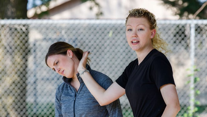Waukesha County Sheiff's Deputy Sarah Kralovetz (right) demonstrates self defense tactics with personal trainer Maren Stodolka during a Community Self Defense Workshop at Indian Head Park in Mukwonago on Saturday, August 19, 2017. The workshop, hosted by Perfect Fit fitness studio, featured instruction on verbal and physical self defense tactics.