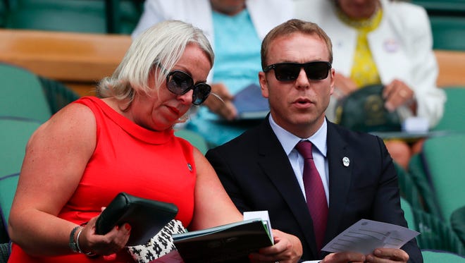British cyclist Chris Hoy takes his seat in the Royal Box on Centre Court on day nine.