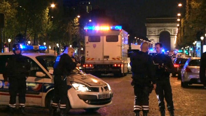 In this image made from video, police attend the scene after an incident on the Champs-Elysees with Arc de Triomphe in background in Paris, Thursday April 20, 2017.  French media are reporting that two police officers were shot Thursday on the famed shopping boulevard. (AP Photo) ORG XMIT: LON146