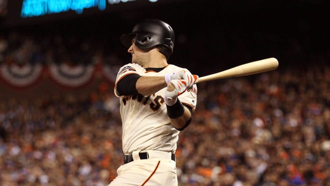 Game 3 in San Francisco: Giants catcher Buster Posey hits an RBI single in the third inning.