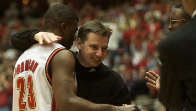 Iowa State's Stevie Johnson (23) is congratulated by head coach Larry Eustachy after the team's 72-61 win over No. 10 Oklahoma State on Feb. 26, 2000, before more than 14,000 fans at Hilton Coliseum.