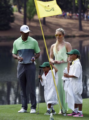 Tiger Woods walks with his children, Charlie and Sam, and Lindsey Vonn, who was then his girlfriend, during the Par 3 Contest prior to the 2015 Masters.