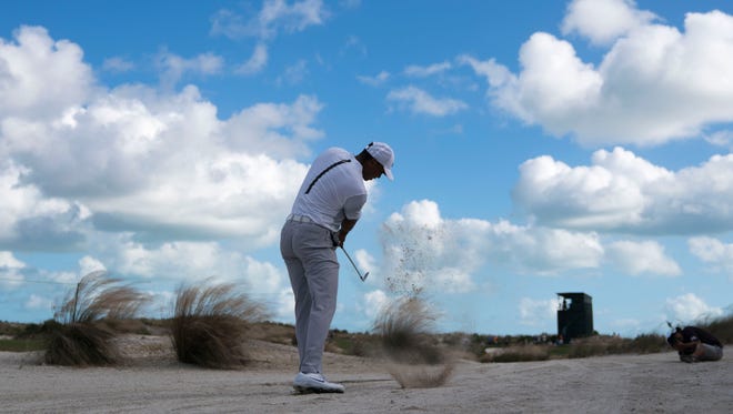 Tiger Woods hits his sand shot on the 16th hole during the second round of the Hero World Challenge golf tournament
