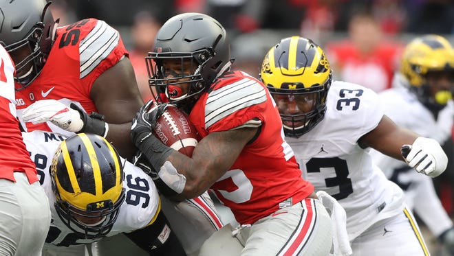 Michigan's Ryan Glasgow (96) and Taco Charlton tackle Ohio State's Mike Weber during the second half Saturday, Nov. 26, 2016 at Ohio Stadium.
