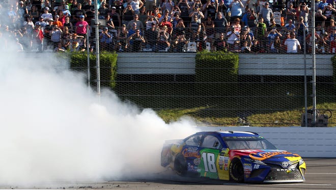Kyle Busch entertains the crowd with a burnout after winning the Overton's 400 on July 30, 2017, for his first career Cup Series victory at Pocono Raceway.