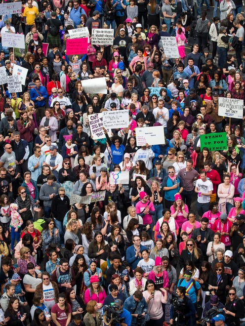 Participants in the Dallas Women's March cheer speakers as they rally outside the at the Communications Workers of America Hall on Saturday, in Dallas, Texas. The Dallas event was held in solidarity with the Women's March on Washington.