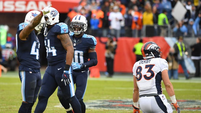 Tennessee TItans players celebrate after recovering a fumble by Denver Broncos tight end A.J. Derby (83) late in the fourth quarter at Nissan Stadium.