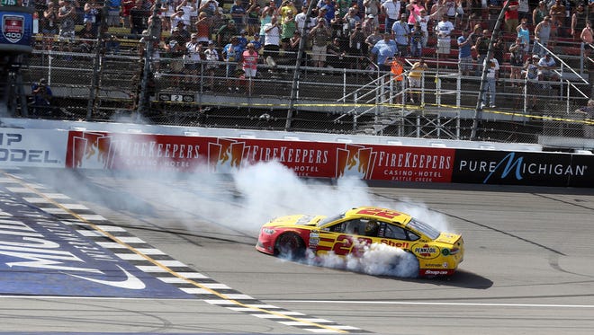 Joey Logano does a burnout after winning the 2016 FireKeepers Casino 400 from the pole at Michigan International Speedway.