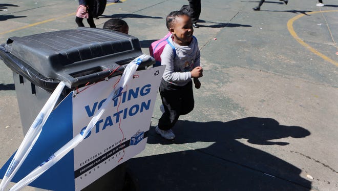 Children leave their school which is being used as polling station, on the eve of the country's municipal elections in Johannesburg, Tuesday, Aug. 2, 2016.