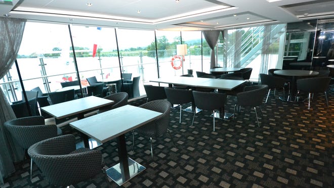 The front of the lounge features tables and chairs where passengers can eat a light lunch.