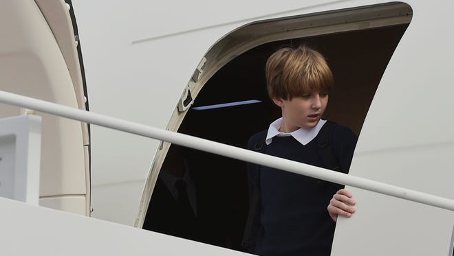 Barron Trump, son of President-elect Donald Trump, steps off a plane upon arrival at Andrews Air Force Base in Maryland,