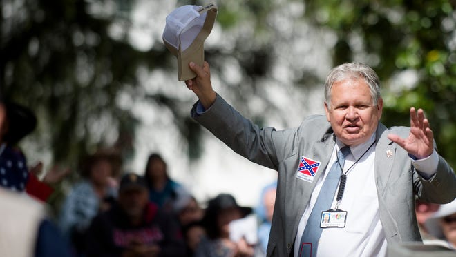 Jim Zeigler, Alabama Auditor, waives during a Confederate Memorial Day service outside the Alabama Capitol on Monday, April 24, 2017, in Montgomery, Ala.