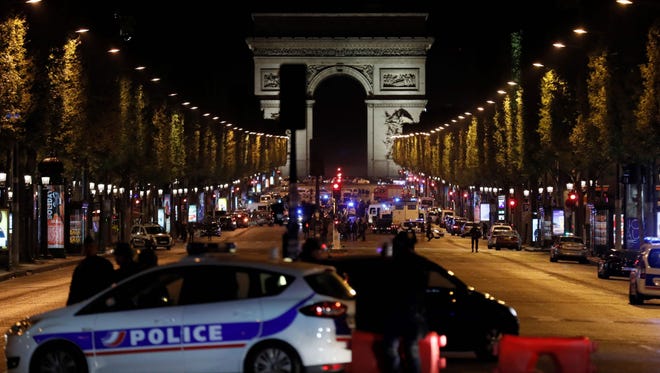 Police officers block the access to the Champs Elysees in Paris after a shooting on April 20, 2017.