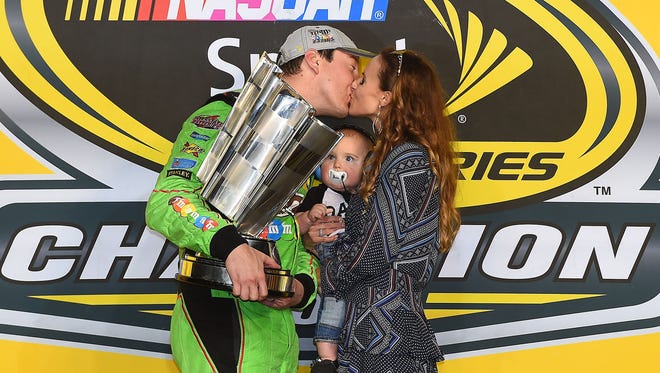 Busch celebrates his first career championship with wife Samantha and son Brexton on Nov. 22, 2015.