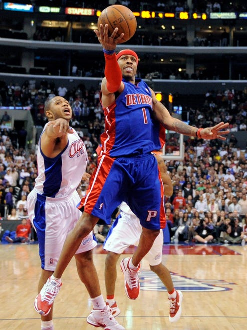 Allen Iverson goes up for a lay up as Eric Gordon defends in the closing seconds of an NBA game.
