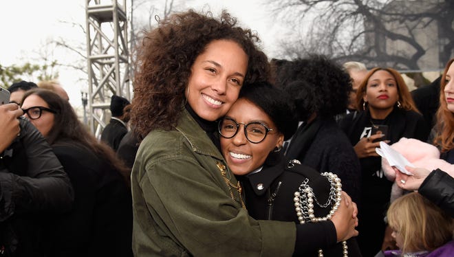 Alicia Keys, left, and Janelle Monae hug it up at the rally at the Women's March on Washington on Jan. 21, 2017.