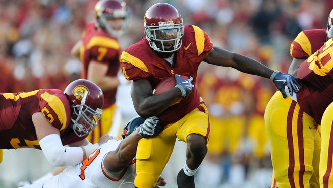 In this 2009 file photo, USC running back Joe McKnight breaks through the line against Oregon State at the Los Angeles Memorial Coliseum.