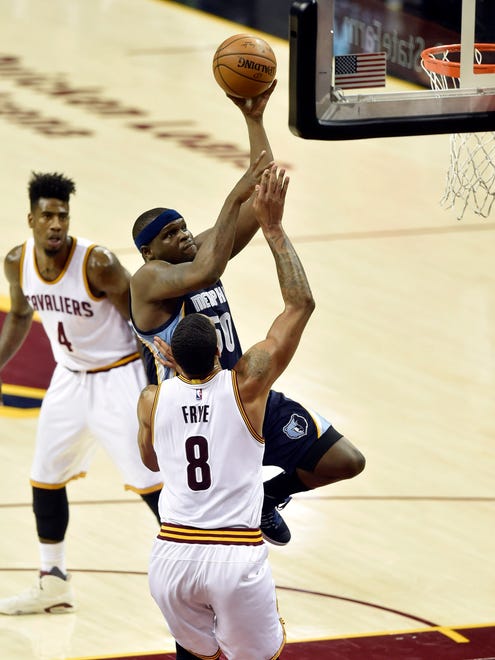 Dec 13, 2016; Cleveland, OH, USA; Memphis Grizzlies forward Zach Randolph (50) drives between Cleveland Cavaliers guard Iman Shumpert (4) and forward Channing Frye (8) in the second quarter at Quicken Loans Arena. Mandatory Credit: David Richard-USA TODAY Sports