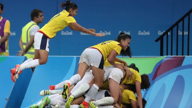 The Colombia women's soccer team celebrates during their first-round tie against the U.S.