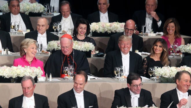 Hillary Clinton, left, Cardinal Timothy  Dolan, archbishop of New York, Donald Trump and Melania Trump attend the Alfred E. Smith Memorial Foundation Dinner at the Waldorf Astoria in New York City Oct. 20, 2016.