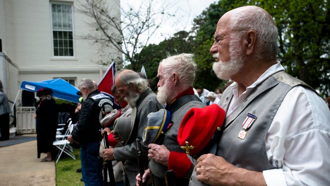 People place their hats on their hearts during a Confederate Memorial Day service outside the Alabama Capitol on Monday, April 24, 2017, in Montgomery, Ala.