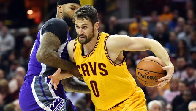 Cleveland Cavaliers forward Kevin Love (0) drives to the basket against Sacramento Kings forward DeMarcus Cousins (15) during the first quarter at Quicken Loans Arena.