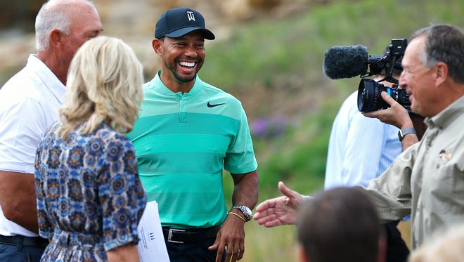 Professional golfer Tiger Woods (middle) and Bass Pro Shops founder and CEO Johnny Morris arrive to a press event announcing a new golf course designed by Tiger Woods with the support of Johnny Morris in Hollister, Mo. on April 18, 2017.