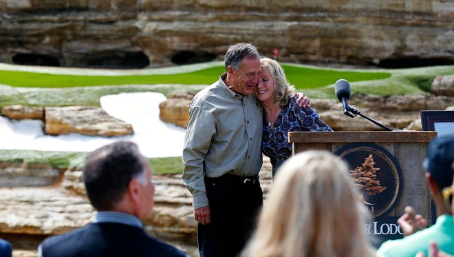 Bass Pro Shops founder and CEO Johnny Morris (left) and Tracey Stewart hug during a press event announcing a new golf course designed by Tiger Woods with the support of Johnny Morris in Hollister, Mo. on April 18, 2017.