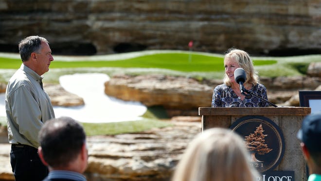 Bass Pro Shops founder and CEO Johnny Morris (left) listens to Tracey Stewart during a press event announcing a new golf course designed by Tiger Woods with the support of Johnny Morris in Hollister, Mo. on April 18, 2017.