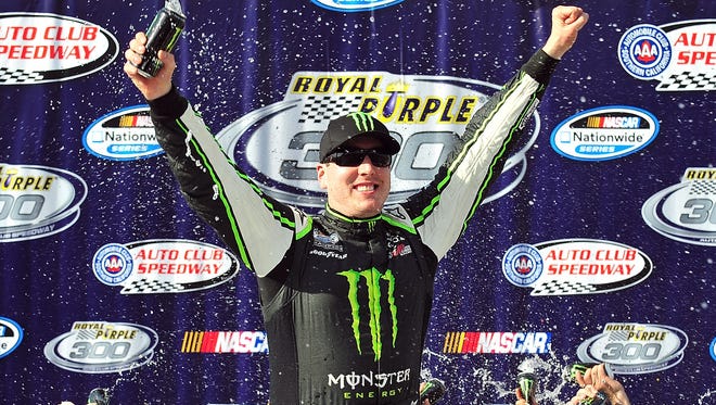 Busch celebrates in victory lane after winning the Royal Purple 300 at Auto Club Speedway on March 23, 2013.