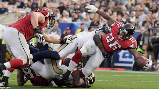 Falcons running back Tevin Coleman (26) is defended by Rams linebacker Alec Ogletree (52) on a 6-yard touchdown run.