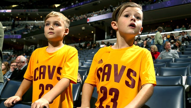 Jax Mross and Braedyn Duffel, both 8, of Harrisburg, Ark.,  watch the Cleveland Cavaliers warm up for their game against the Grizzlies. The game was Duffel's Christmas present and he was hoping to see LeBron James. When his father, Jeremy, broke the news to him that LeBron would not be playing Braedyn Duffel said, "That's okay, maybe I can see Kevin Love." Love also did not play for the Cavaliers.
