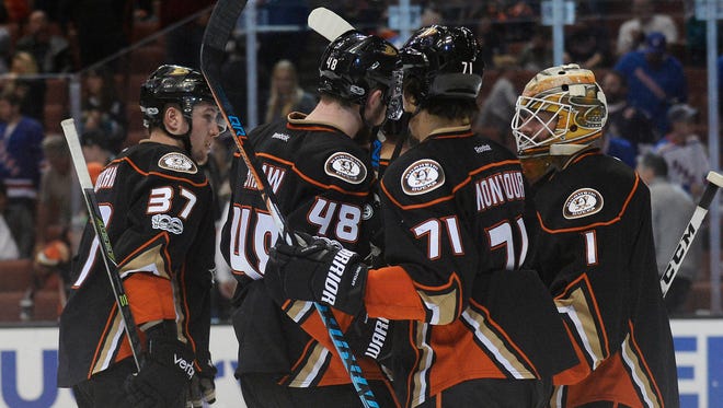 Ducks goalie Jonathan Bernier, right, and his teammates celebrate their 6-3 victory against the Rangers at Honda Center in Anaheim.