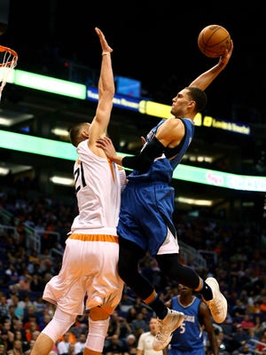 Minnesota Timberwolves guard Zach LaVine (right) goes up for a dunk over Phoenix Suns center Alex Len.
