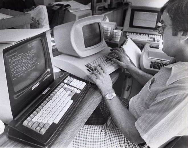 On July 1, 1980, The Dispatch began beaming news stories through the CompuServe dial-up service. The newspaper was the first daily newspaper in the country to test a new technology that enabled the day’s news to flow into home computers at 300 words per minute. Users paid $5 per hour for the service, billed in one-minute increments. "To become a subscriber," The Dispatch reported, "a resident will have to have a home computer. Such equipment is now available in electronics shops."
In this photo, Dispatch copy editor Bill Prewitt, who coordinated the newspaper-by-computer project in the news department, sits in front of computer equipment used in transmitting the electronic newspaper.