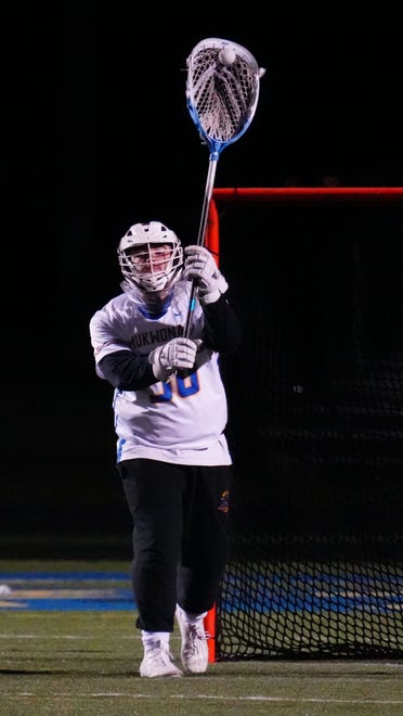 Mukwonago goalie Evan Ban (30) sends a pass downfield during the lacrosse match at home against Homestead on Tuesday, March 19, 2024.