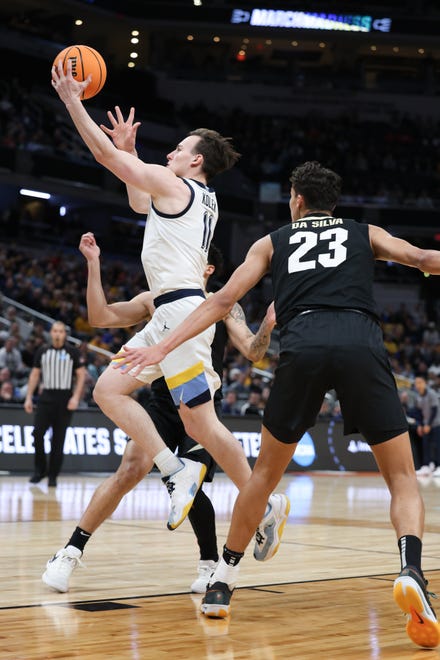 Mar 24, 2024; Indianapolis, IN, USA; Marquette Golden Eagles guard Tyler Kolek (11) drives to the basket past Colorado Buffaloes forward Tristan da Silva (23) during the first half at Gainbridge FieldHouse. Mandatory Credit: Trevor Ruszkowski-USA TODAY Sports