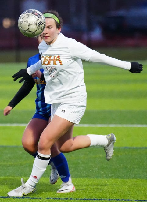 Divine Savior Holy Angels' Mary McLaughlin (22) runs down a pass during the match against Catholic Memorial at Mindiola Park in Waukesha, Tuesday, March 26, 2024.