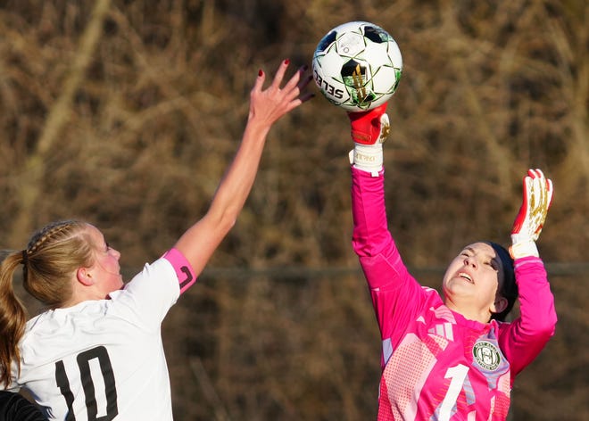 West Allis Hale keeper Bella Royse (1) swats the ball away from Ozaukee/Random Lake co-op's Meredith Clark (10) during the match at West Allis Athletic Complex, Thursday, March 28, 2024. No penalty was called on the play.