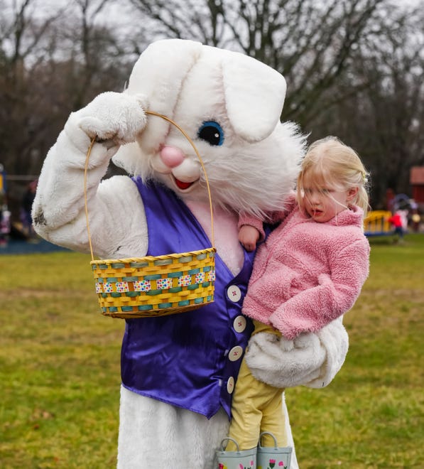 Three-year-old Hannah Schick of Oconomowoc shows her candy-filled egg collection to the Easter Bunny during the annual Okauchee Lions Easter Egg Hunt at Lions Park on Saturday, March 30, 2024. The free family event is hosted by the Okauchee Lions Club.