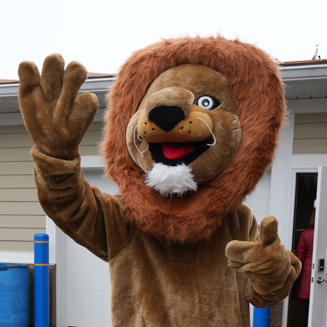 Leo the Lion waves to youngsters during the annual Okauchee Lions Easter Egg Hunt at Lions Park on Saturday, March 30, 2024. The free family event is hosted by the Okauchee Lions Club.