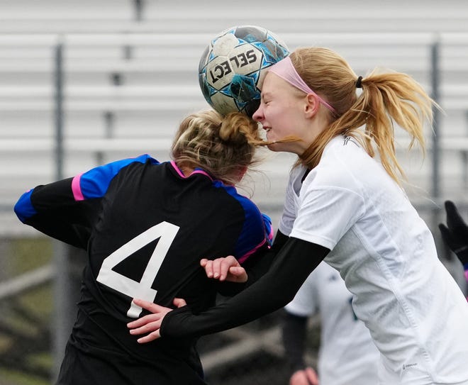 Waukesha West's Megan Thomsen (4) battles for a header against Kettle Moraine Lutheran's Lauryn Haines (5) during the match at Waukesha West on Saturday, March 30, 2024.