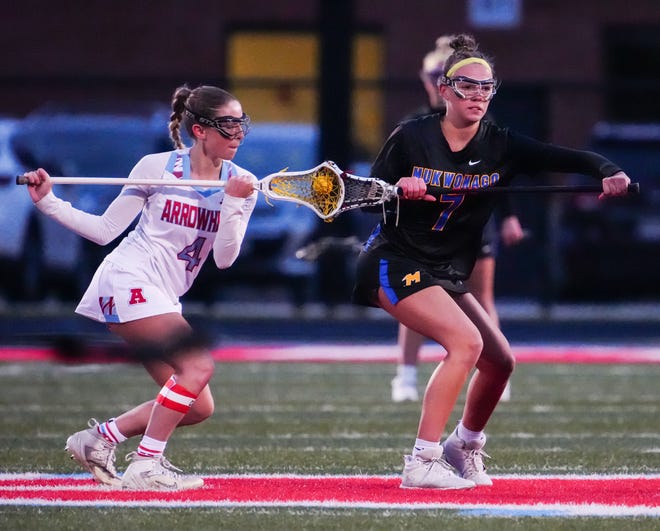 Arrowhead's Kendall Danielson (4) faces off with Mukwonago's Delaney Searing (7) during the match at Arrowhead on Thursday, April 4, 2024.