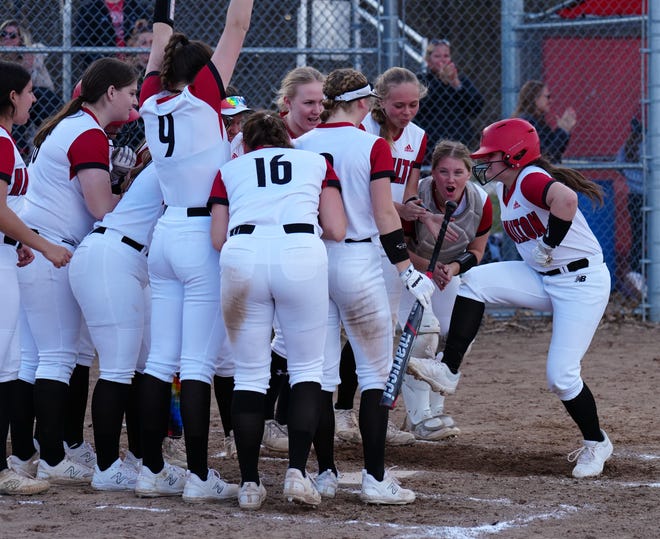Sussex Hamilton teammates welcome Izzy McCann (17) to the plate after a home run against Divine Savior Holy Angels on Tuesday, April 9, 2024.