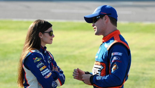 Danica Patrick, left, talks with Ricky Stenhouse Jr. on pit road during qualifying for a NASCAR Nationwide series race at Texas Motor Speedway on Nov. 3, 2012.